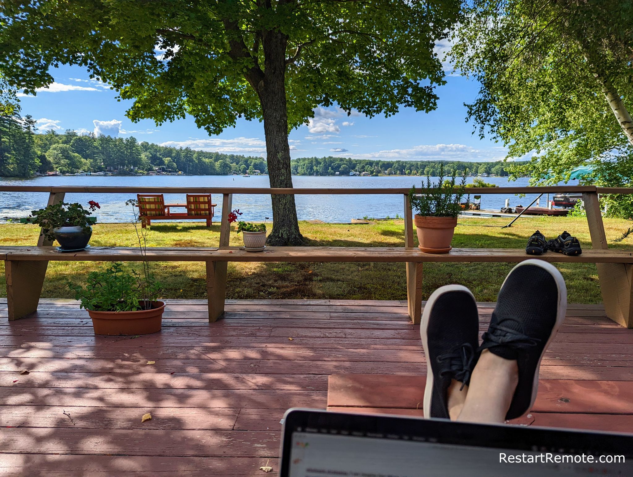 working on a laptop in New Hampshire overlooking lake